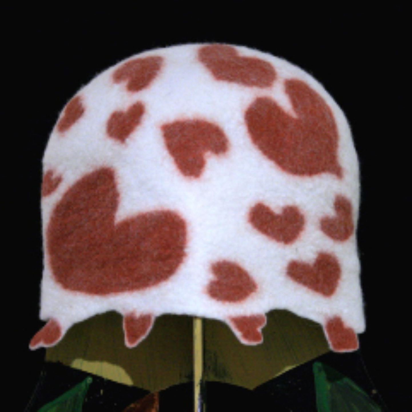A white hat with brown hearts on it