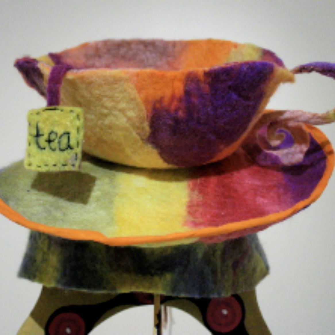 A colorful teacup with a tag that says tea