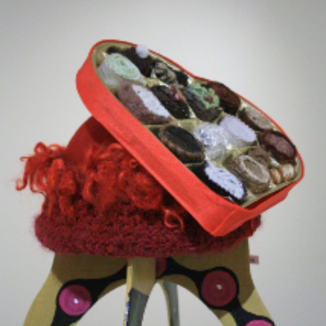 A red bag filled with a variety of items