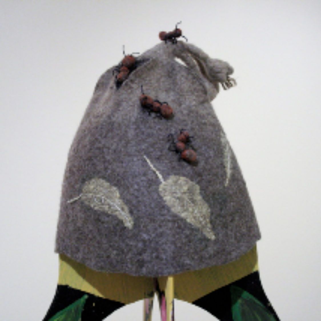 A hat with feathers and ants on it