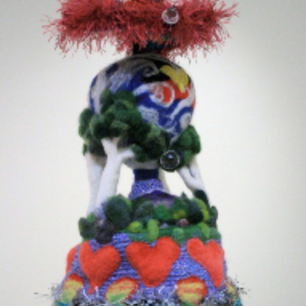 A colorful sculpture with hearts and trees on it