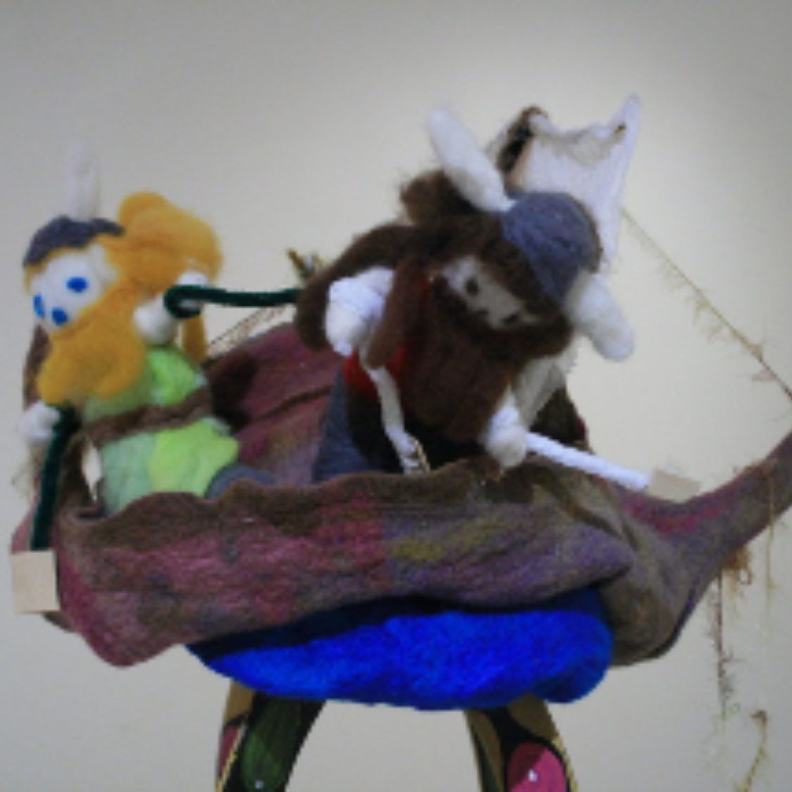 A stuffed animal is sitting on a blue blanket