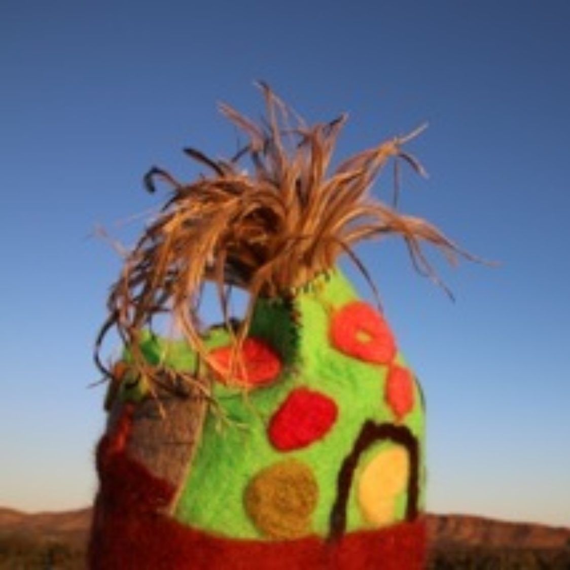 A green and red hat with flowers on it