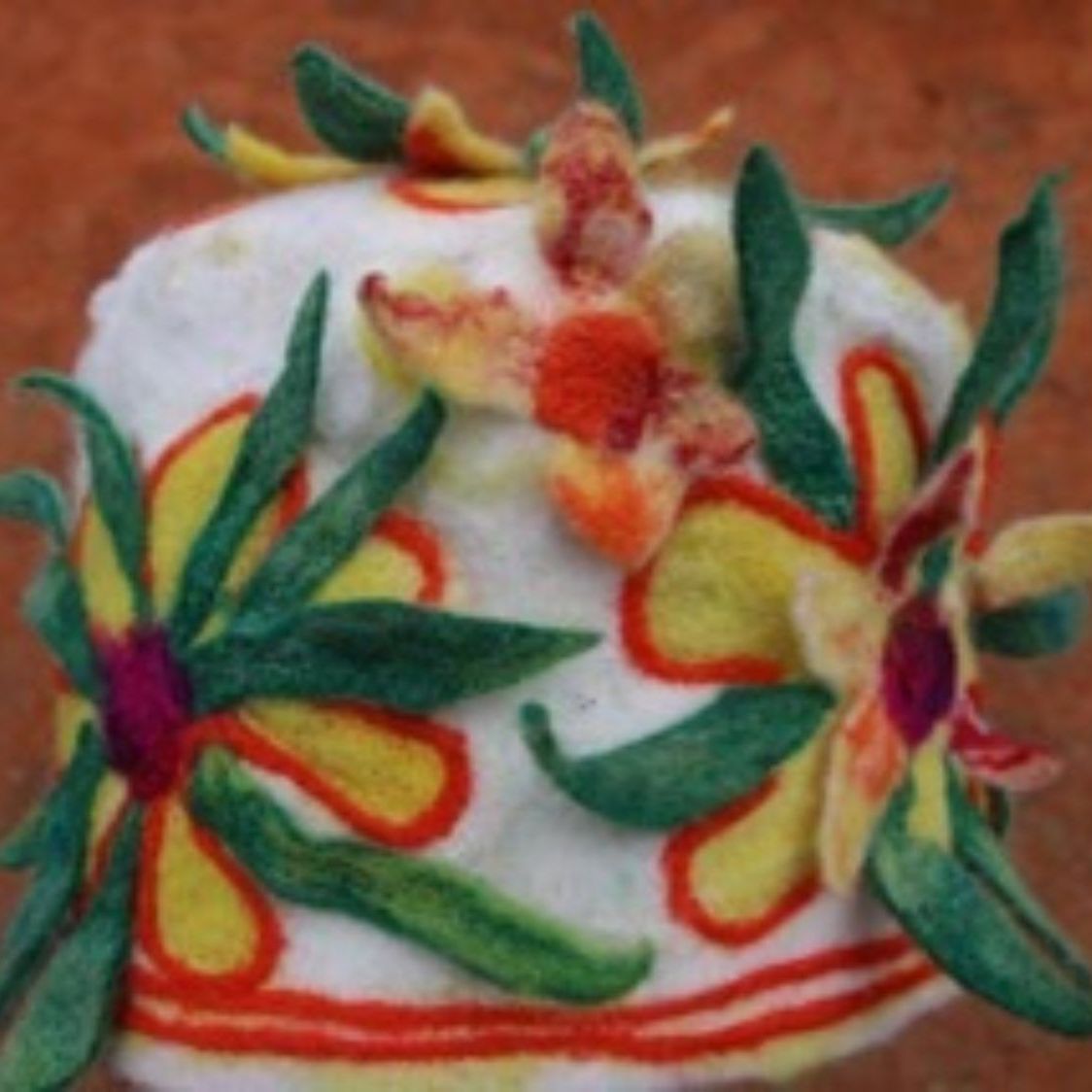 A white cake with flowers and leaves on it