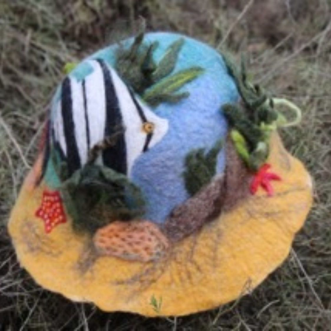 A hat with a fish and plants on it