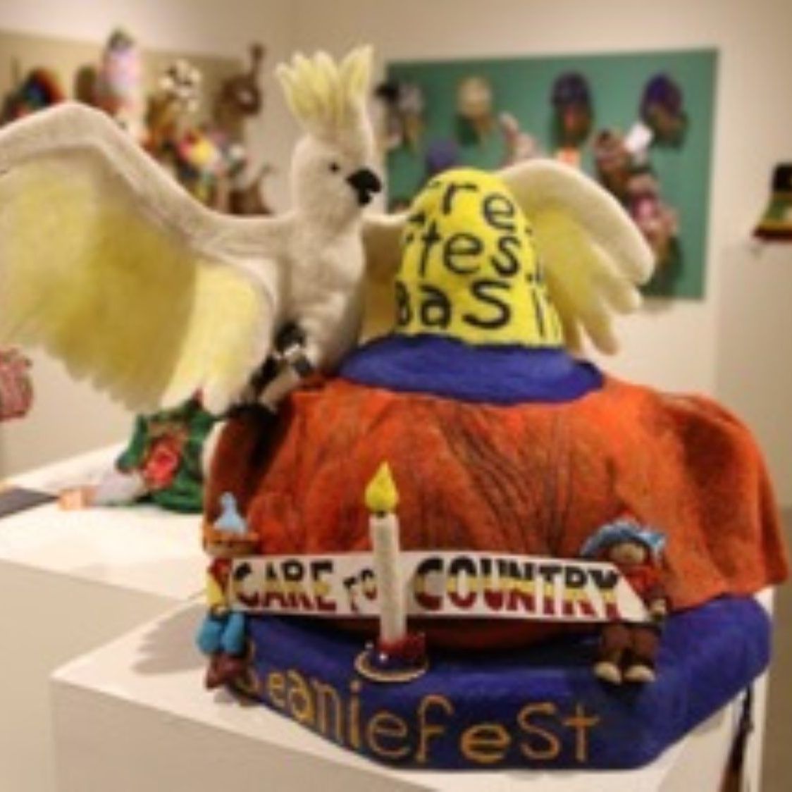 A beaniefest hat with a bird on top of it