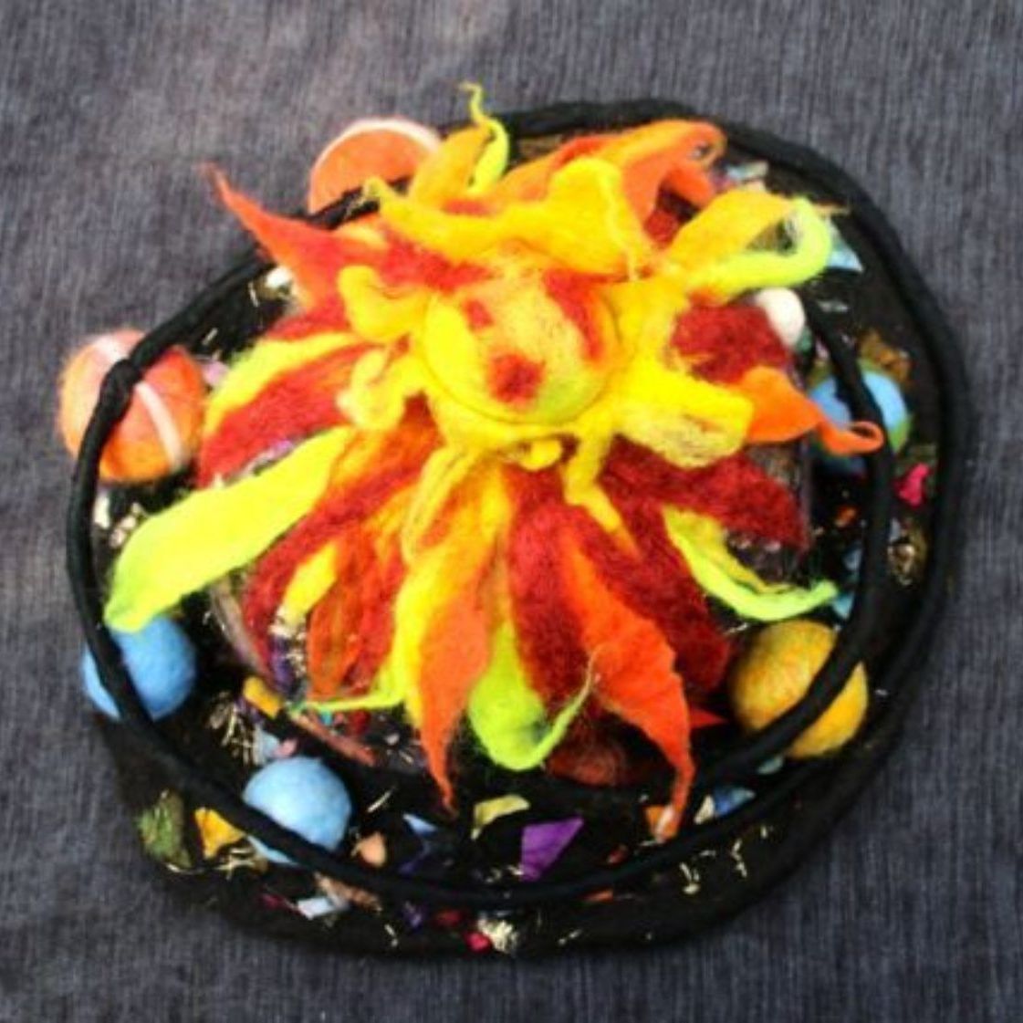 A colorful hat with a flower on top of it