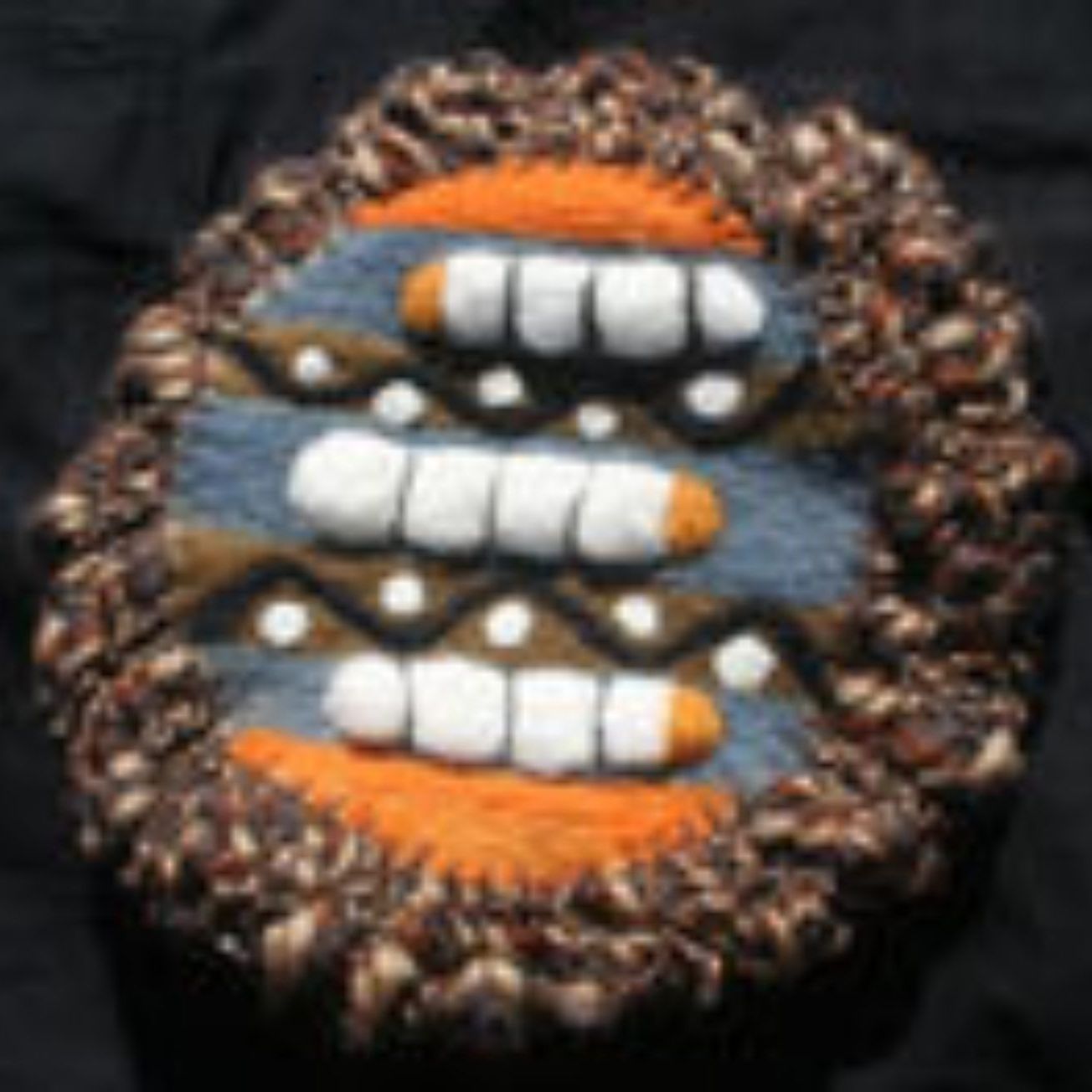A close up of a knitted object with teeth on it