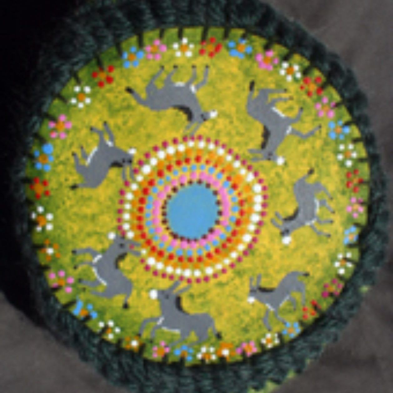 A colorful circle with horses and flowers on it