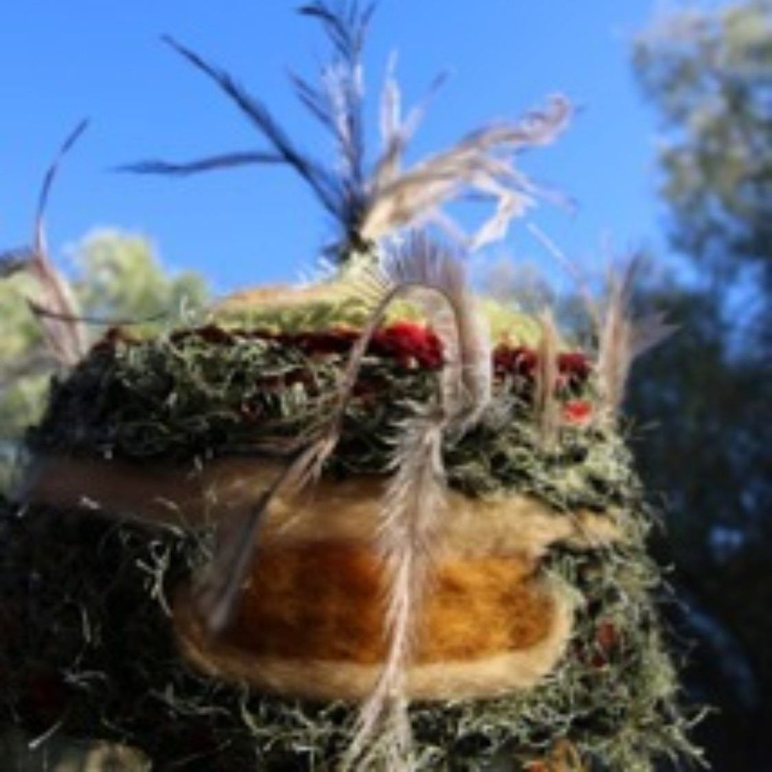 A close up of a stuffed animal with feathers on it