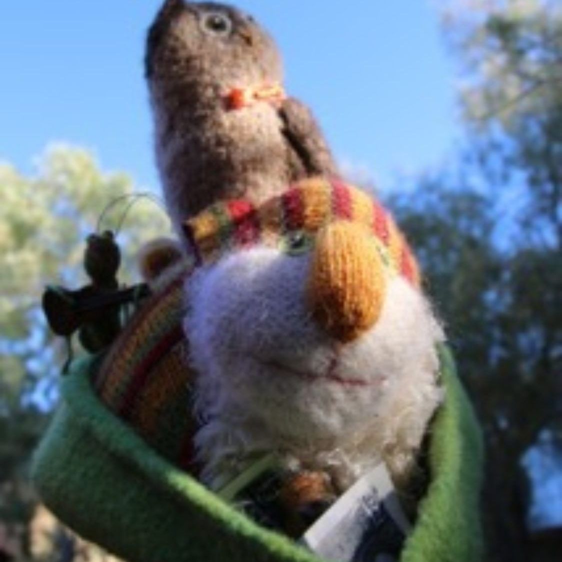 A stuffed animal with a scarf around its neck