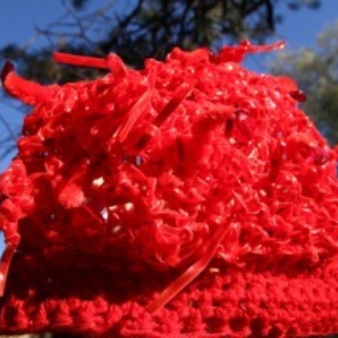 A close up of a red object with a blue sky in the background