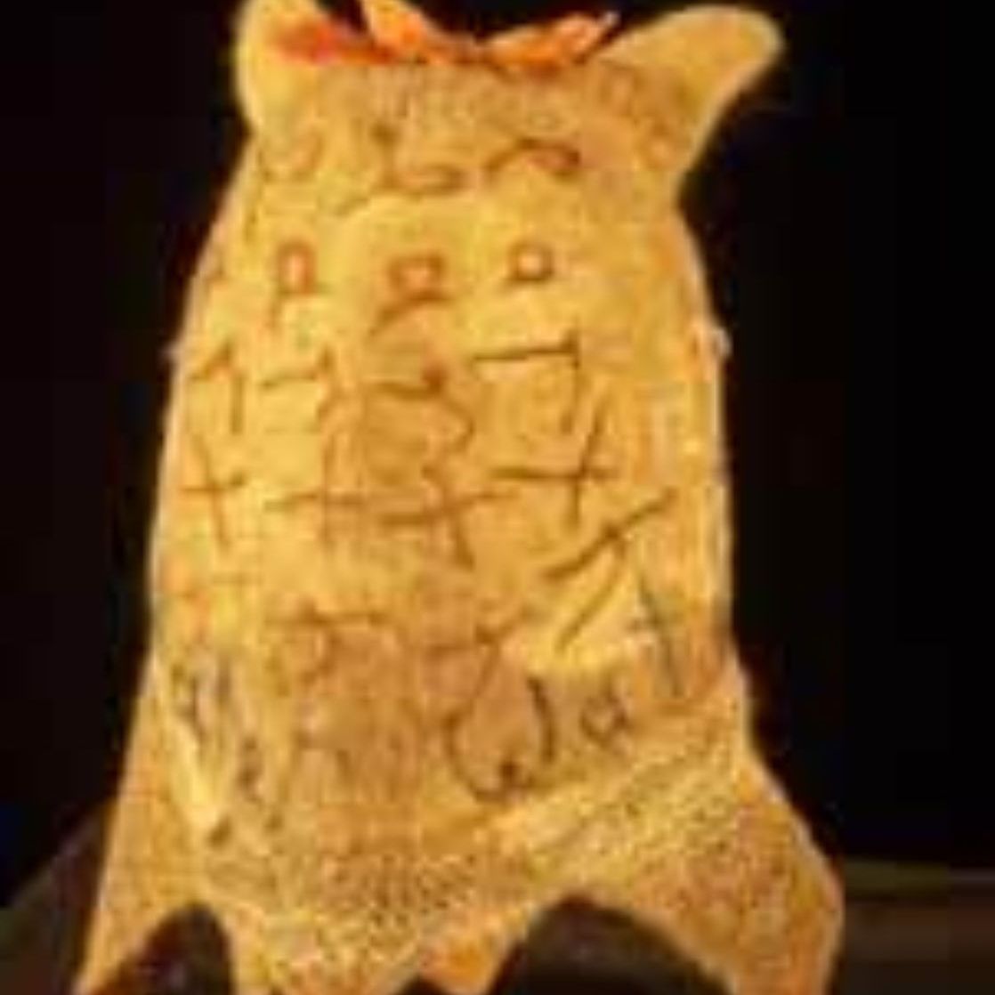 A close up of a yellow object with a black background.