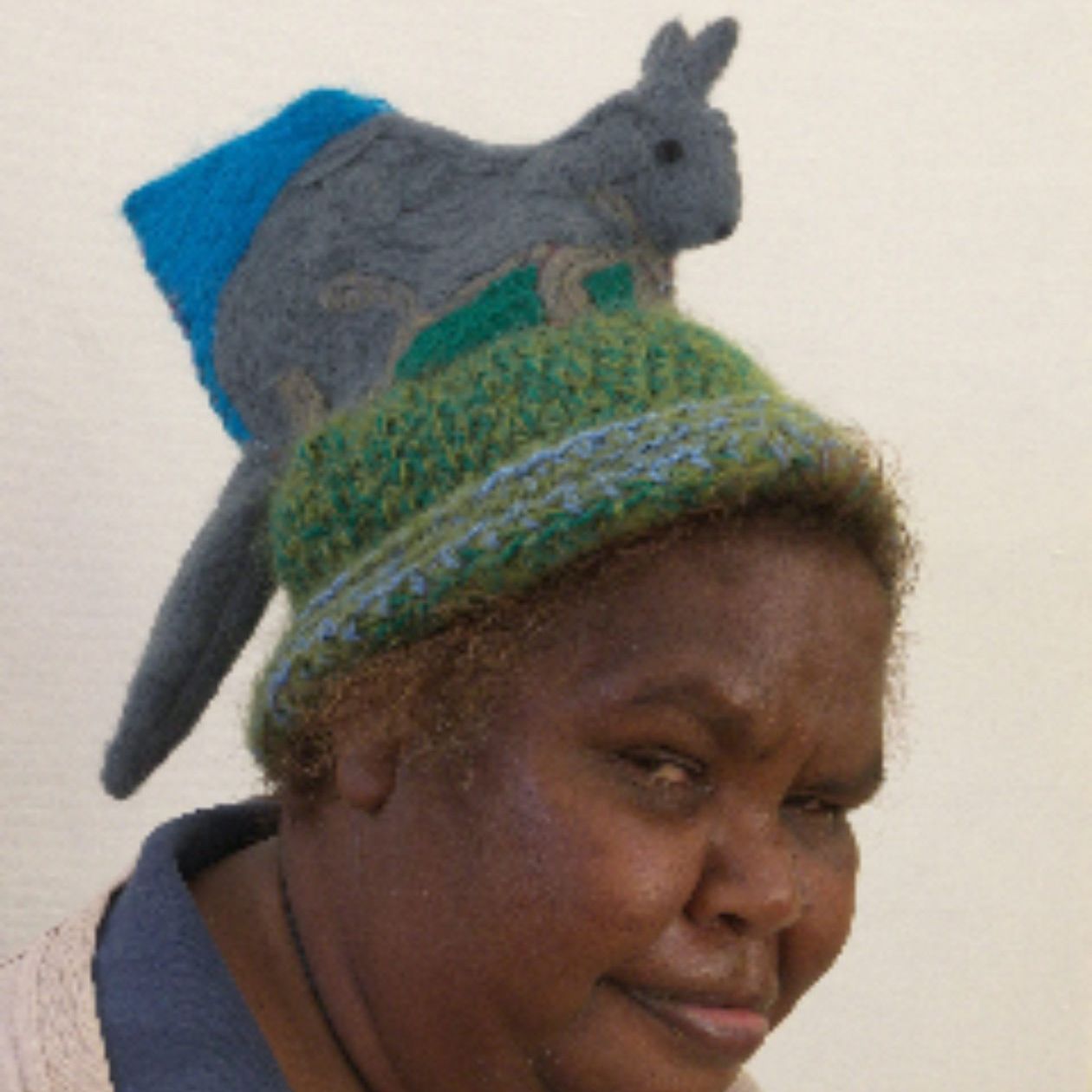A woman wearing a hat with a rabbit on it