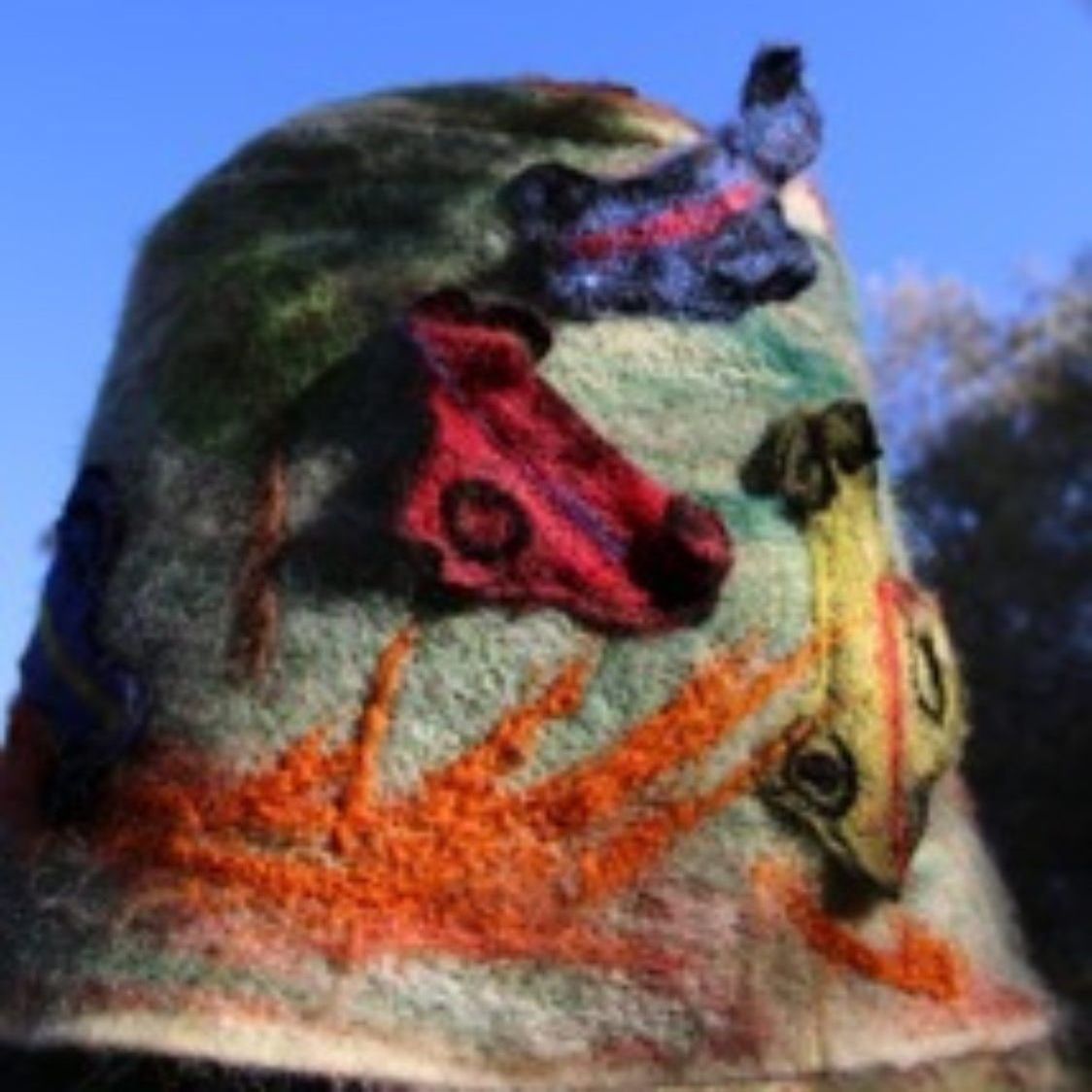 A hat with a painting of horses on it