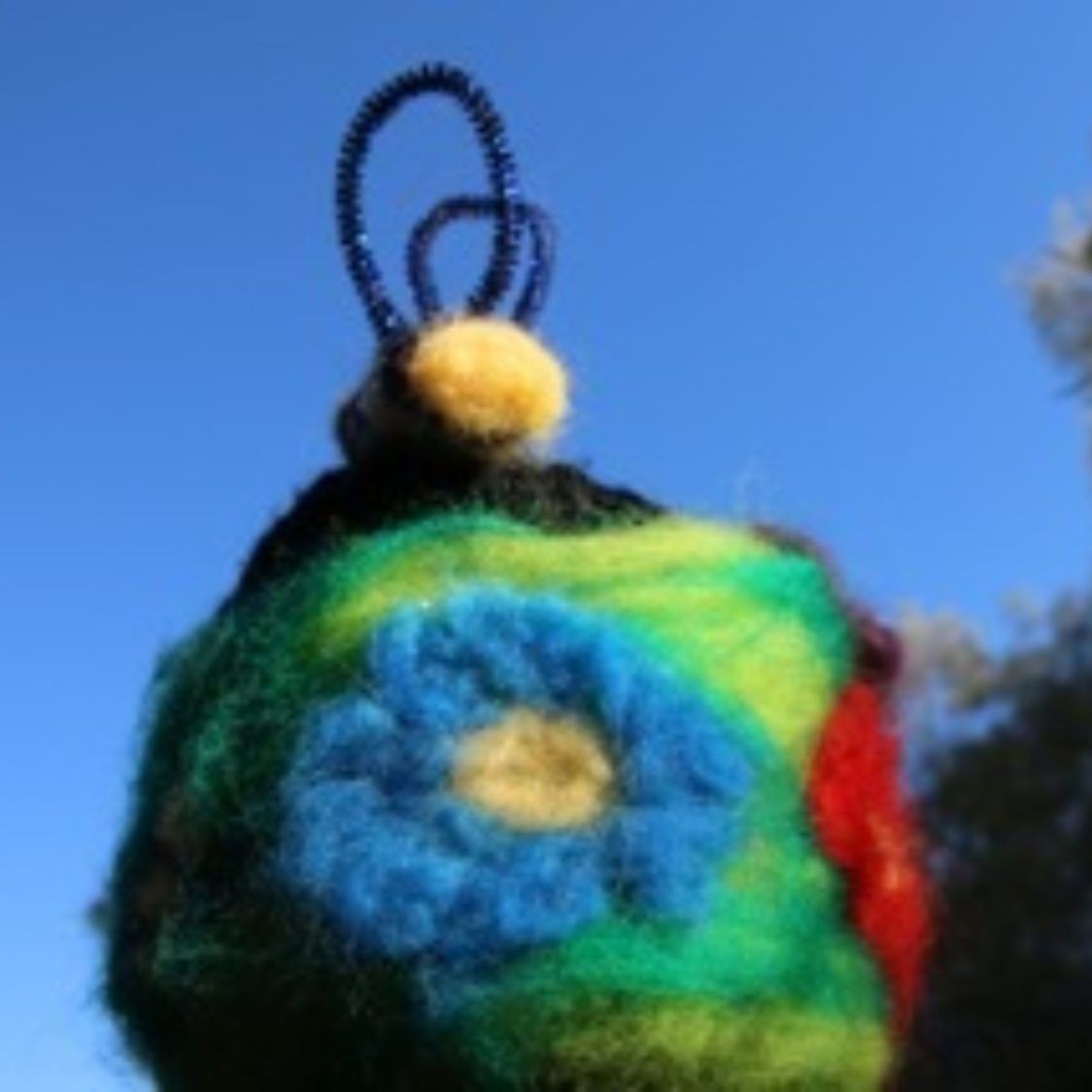 A close up of a colorful object with a flower on it