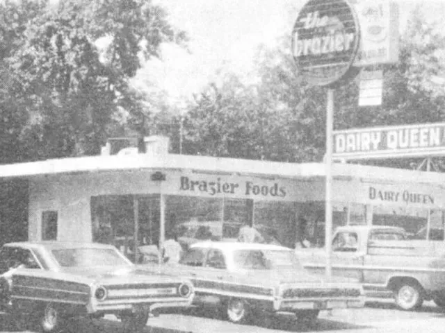 Brazier Foods and Dairy Queen restaurant from the 1960s or 70s with cars parked out front.