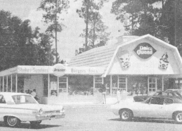 Vintage Dairy Queen with cars parked in front.