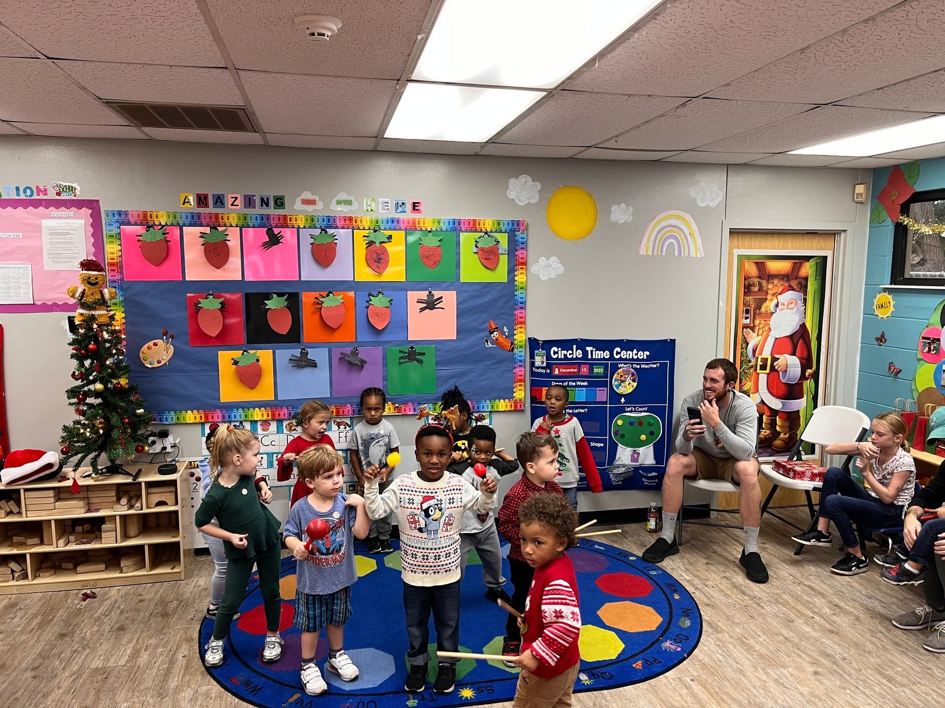 A group of children are standing in a classroom.