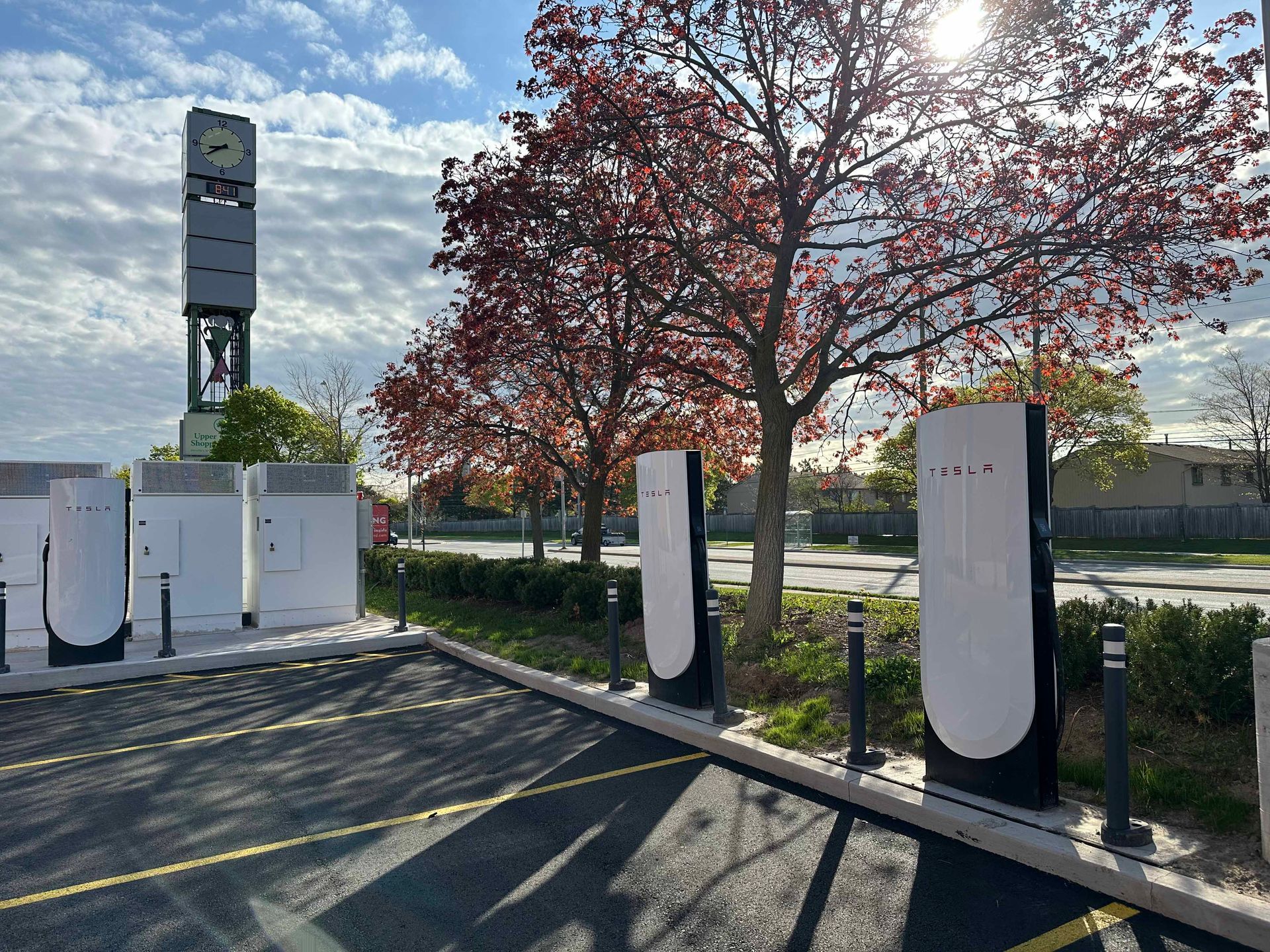 A red tesla model s is being charged at a tesla charging station.