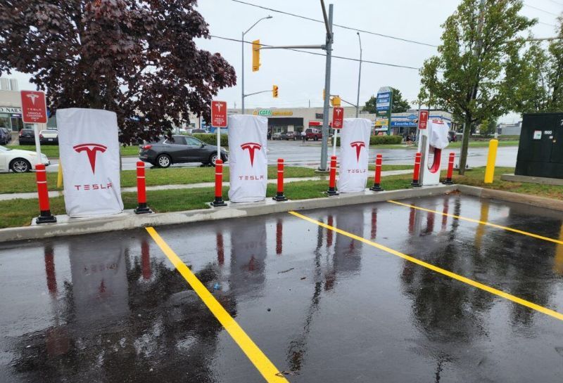A row of tesla charging stations in a parking lot