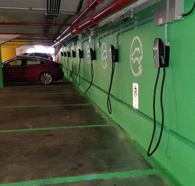A row of charging stations in a parking garage
