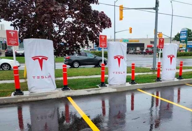 A row of tesla charging stations in a parking lot
