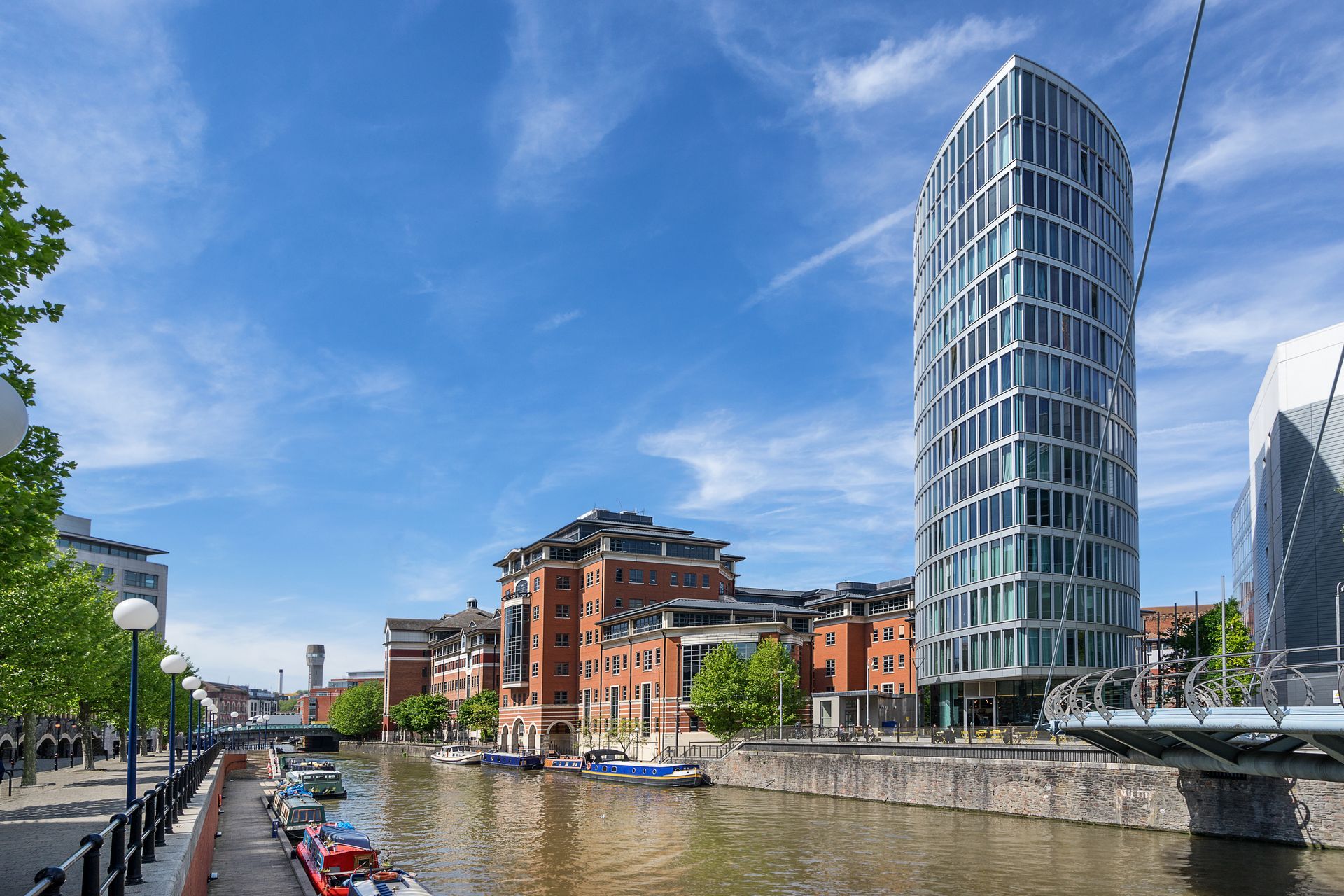 A bridge over a river with a tall building in the background