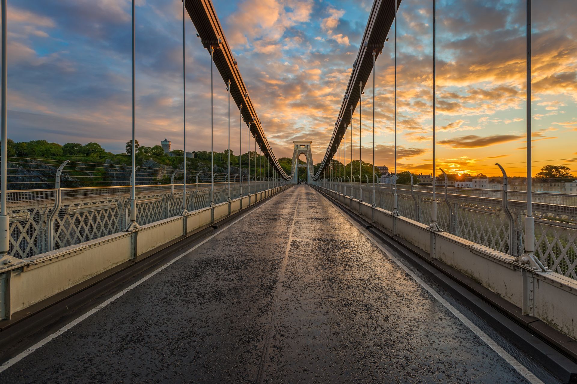An empty bridge with a sunset in the background.