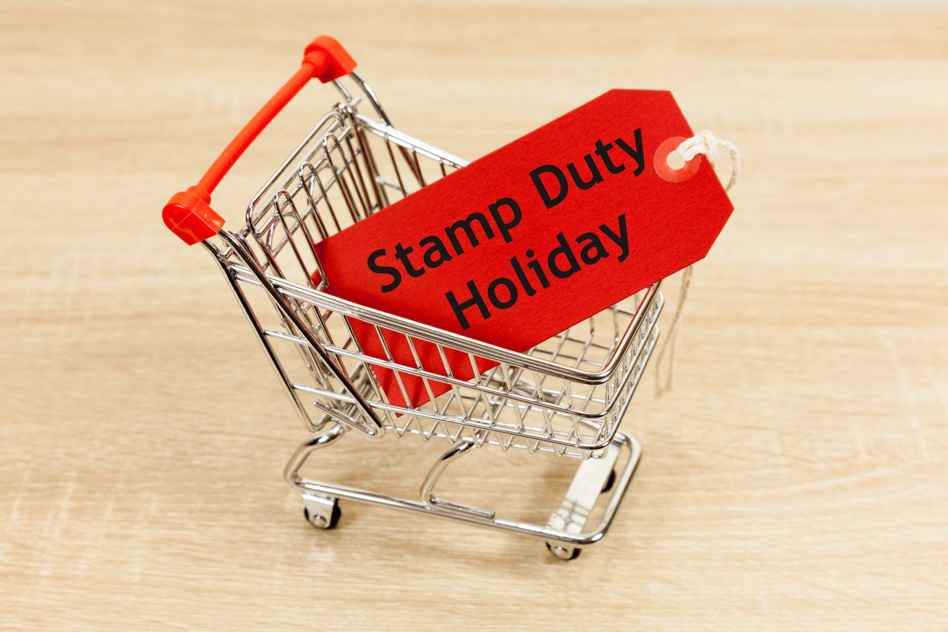 A shopping cart with a red tag that says stamp duty holiday