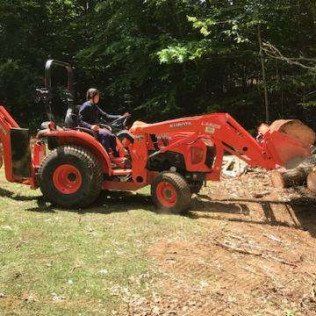 Worker Doing Land Clearing With Front Loader