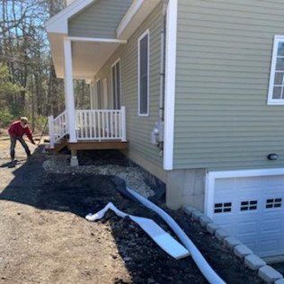 Worker Installing New French Drain for a Residential House