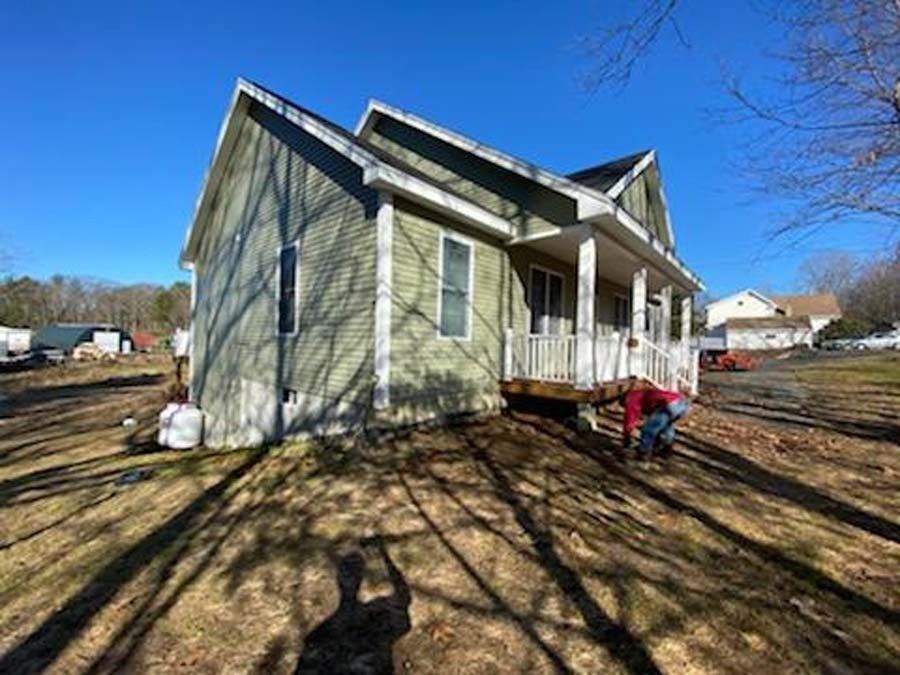Worker in Front of a House