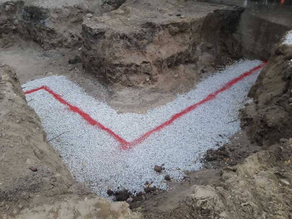 A red line is painted on a pile of gravel.