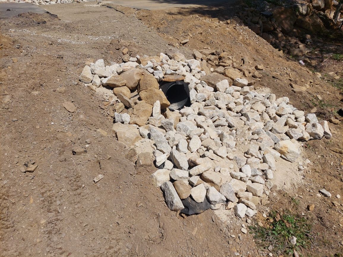 A pile of rocks and dirt on the side of a road