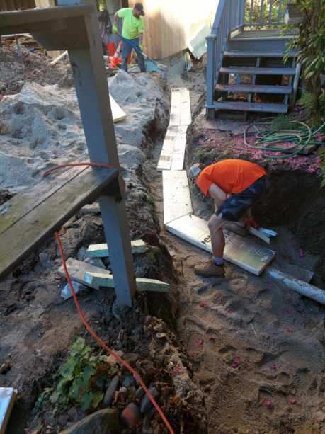 Worker Covering Utility Pipes