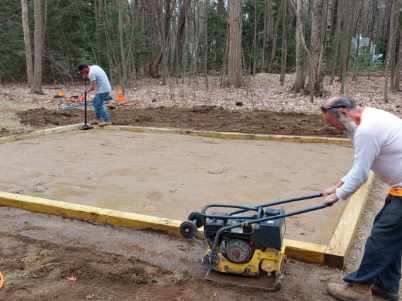 Worker Grading an Open Area Using a Compactor