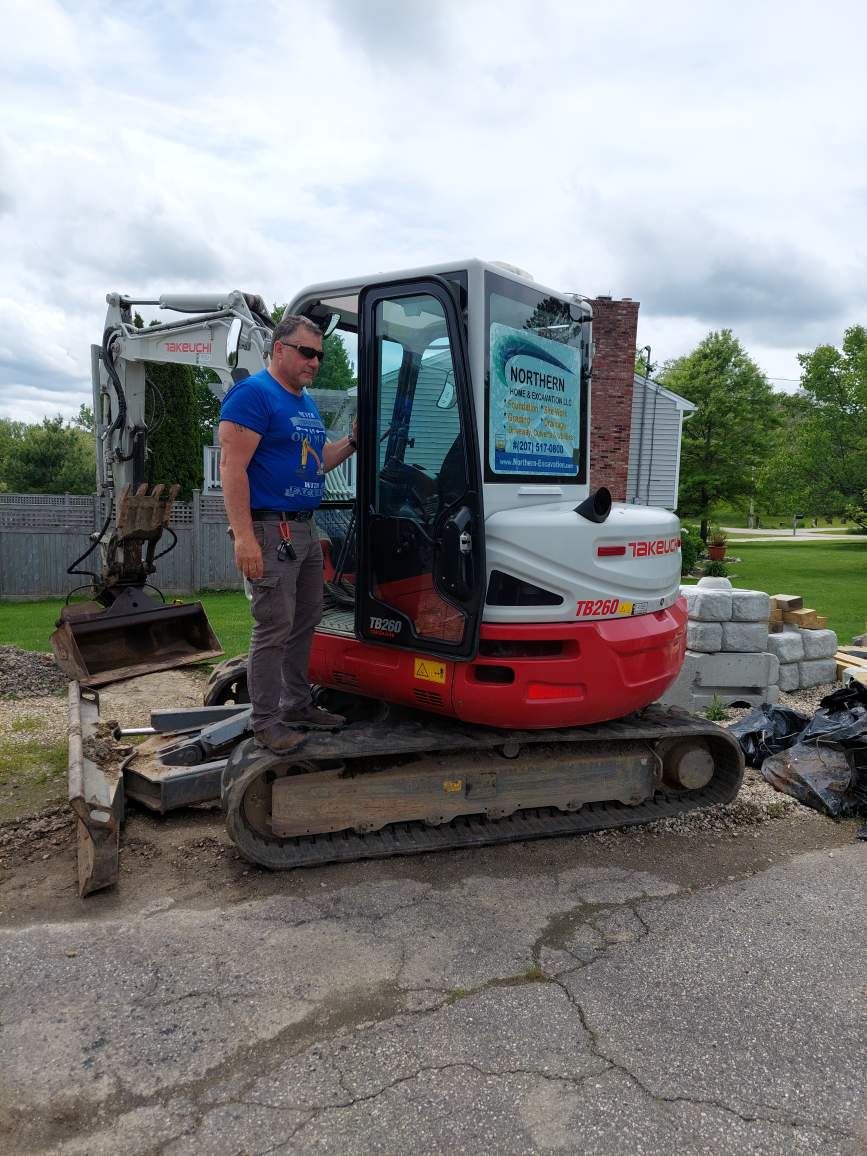 Worker Standing on a Excavator