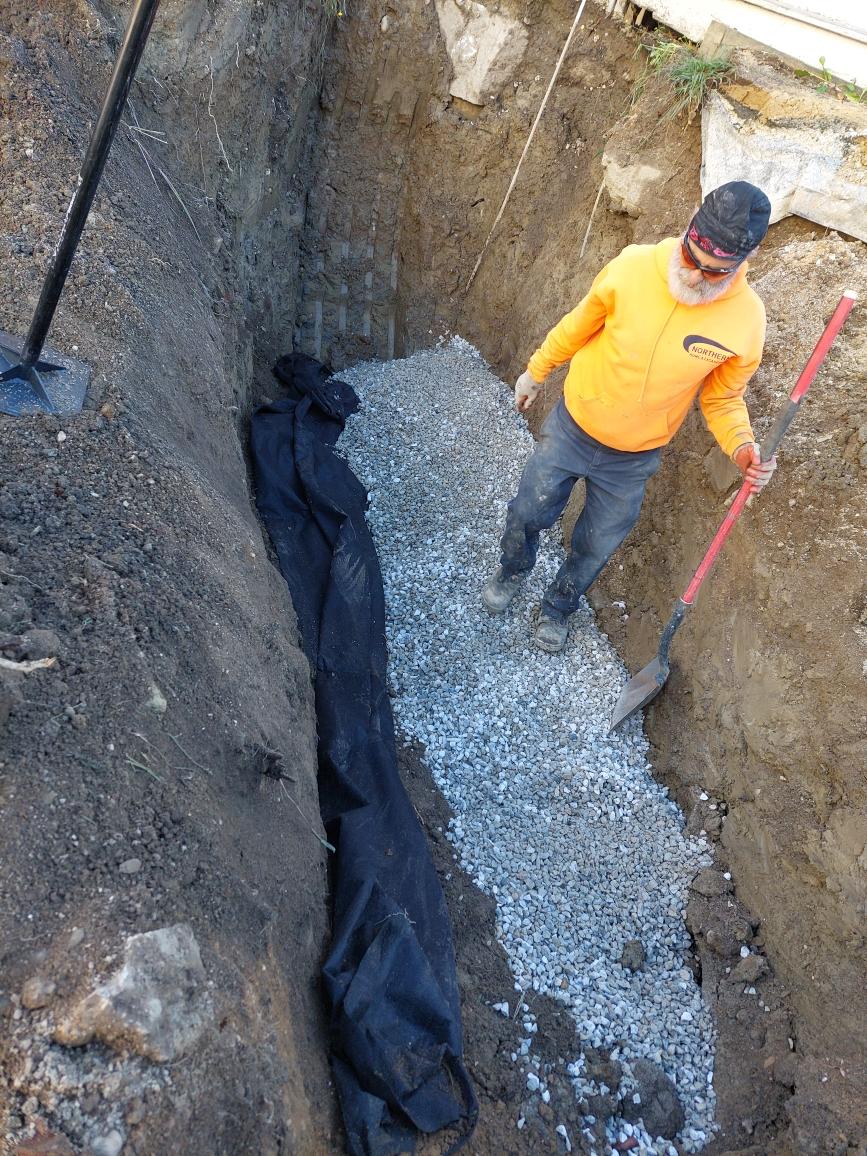 Worker Adding Gravel on the Excavated Area