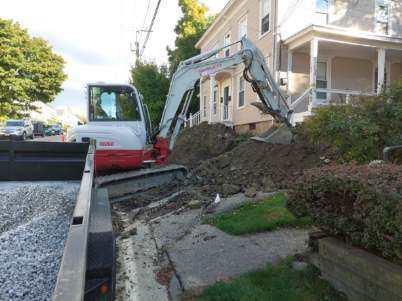 Worker Operating a Small Excavator