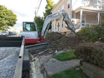 Backhoe Operated by a Professional Worker Excavating Sewer Lines