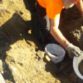 Worker Collection Soil From Excavation