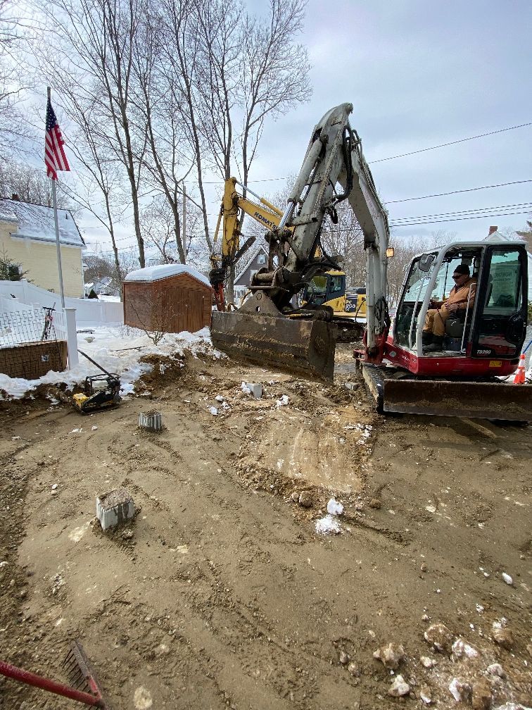 A man is driving a bulldozer on a dirt road.