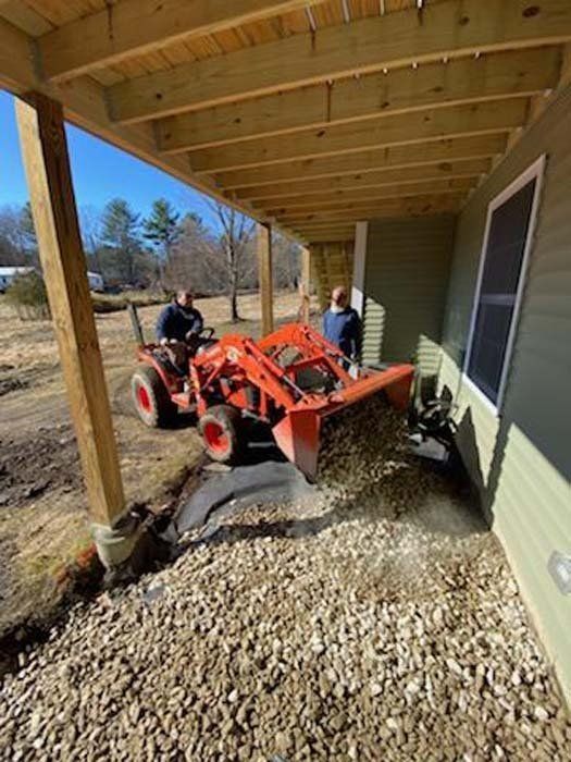 Workers Pouring Gravel Using a Loader Truck