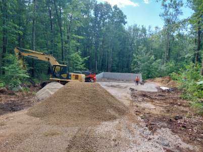 A construction site with a pile of dirt and a bulldozer.