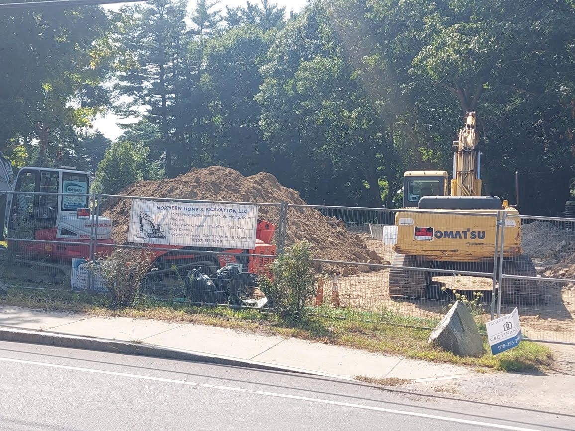 A doosan excavator is parked on the side of the road