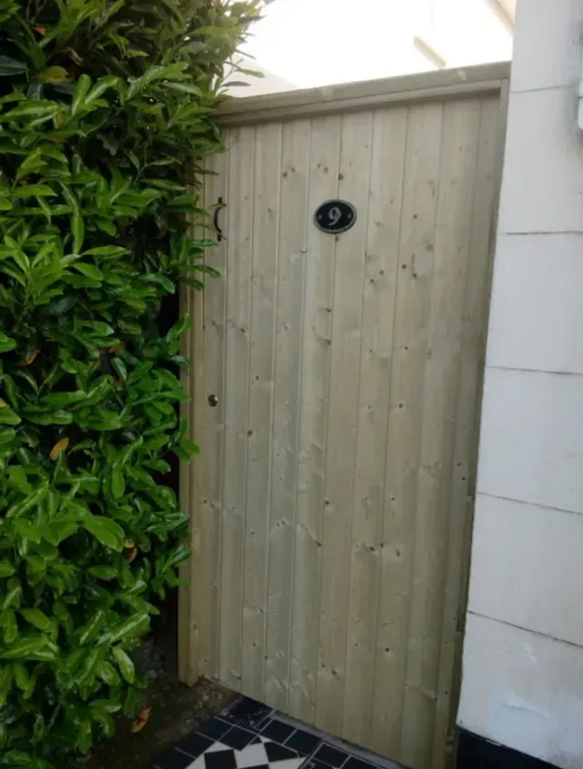 A wooden gate with the number 9 on it