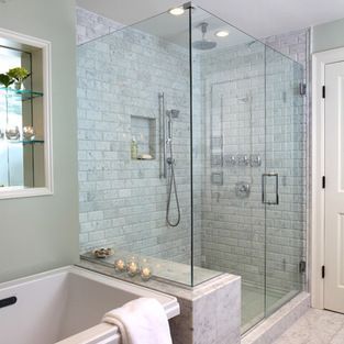 Bathroom with a white tub, glass shower, mosaic tile, and a window with frosted glass and a shade.