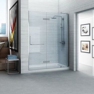 Modern bathroom with a glass shower door, shower head, and silver fixtures.