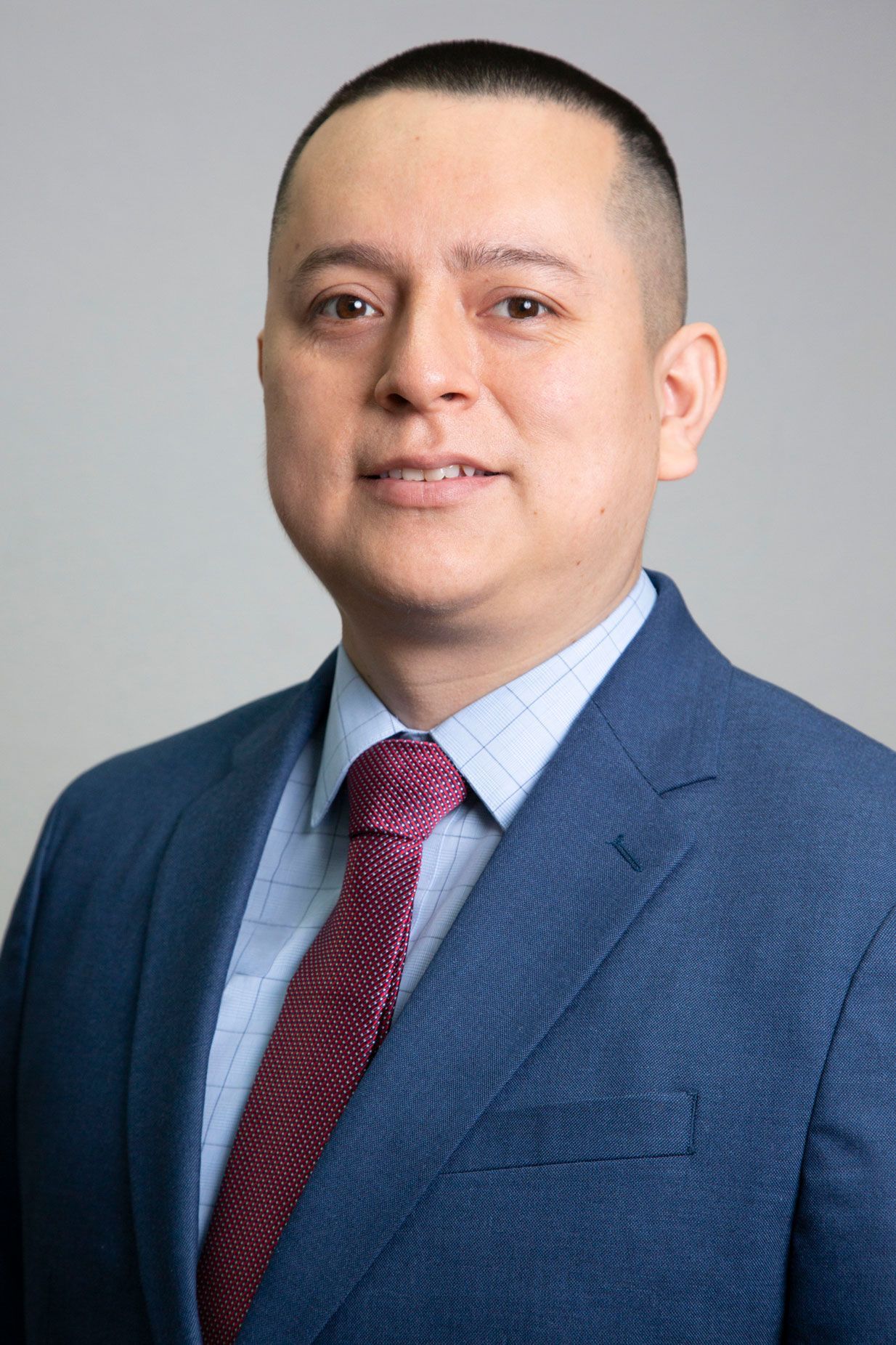 A man in a suit and tie is smiling for the camera.